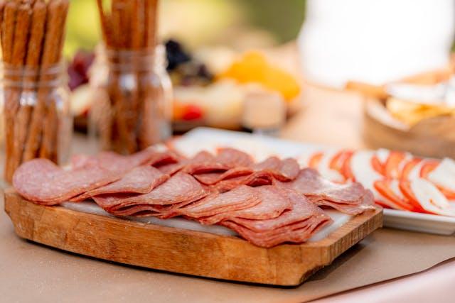 Sliced salami On Brown Wooden Chopping Board
